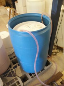 Our latest set up for cold stabilization.  The chardonnay is in the 30 gallon container just CHILLIN' in a nice bath of cold water.  Coolant is circulating in and out those pink hoses.  Inside the barrel, unseen is copper tubing.